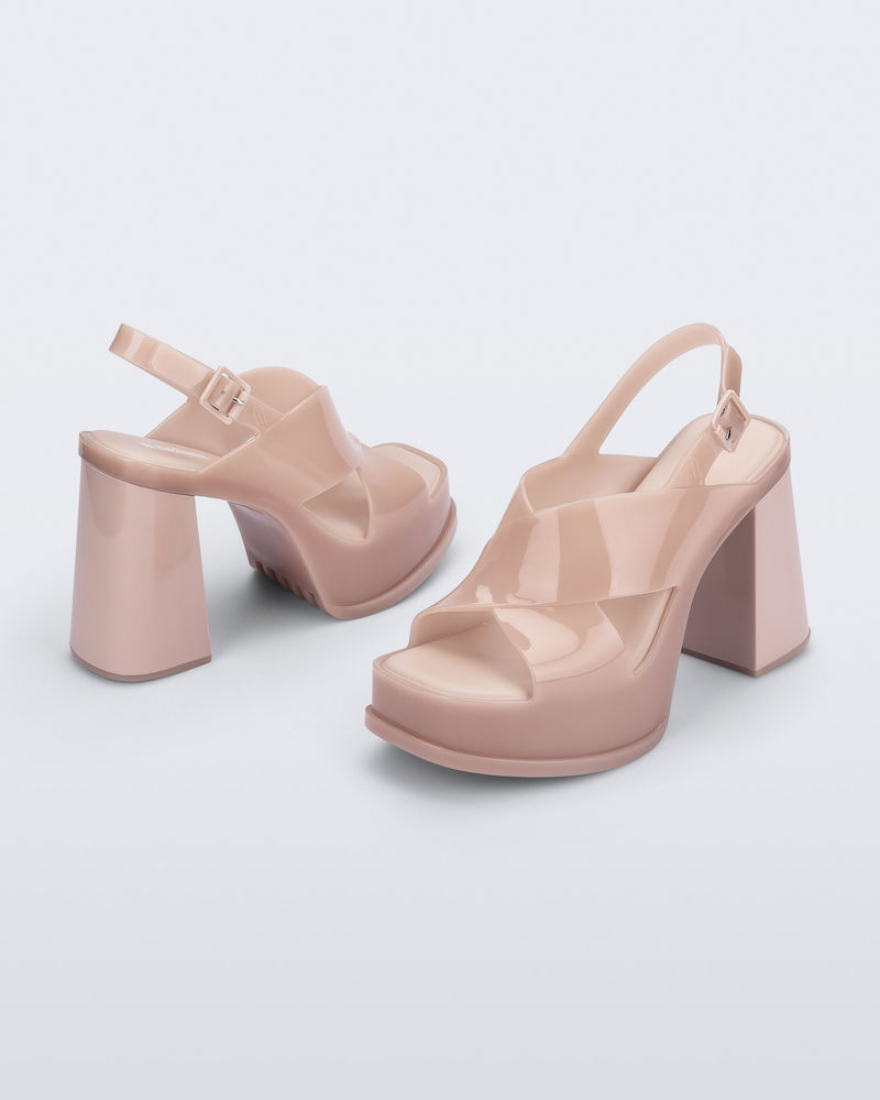 Back and angled view of a pair of milky pink Dance Heel platforms with back adjustable strap
