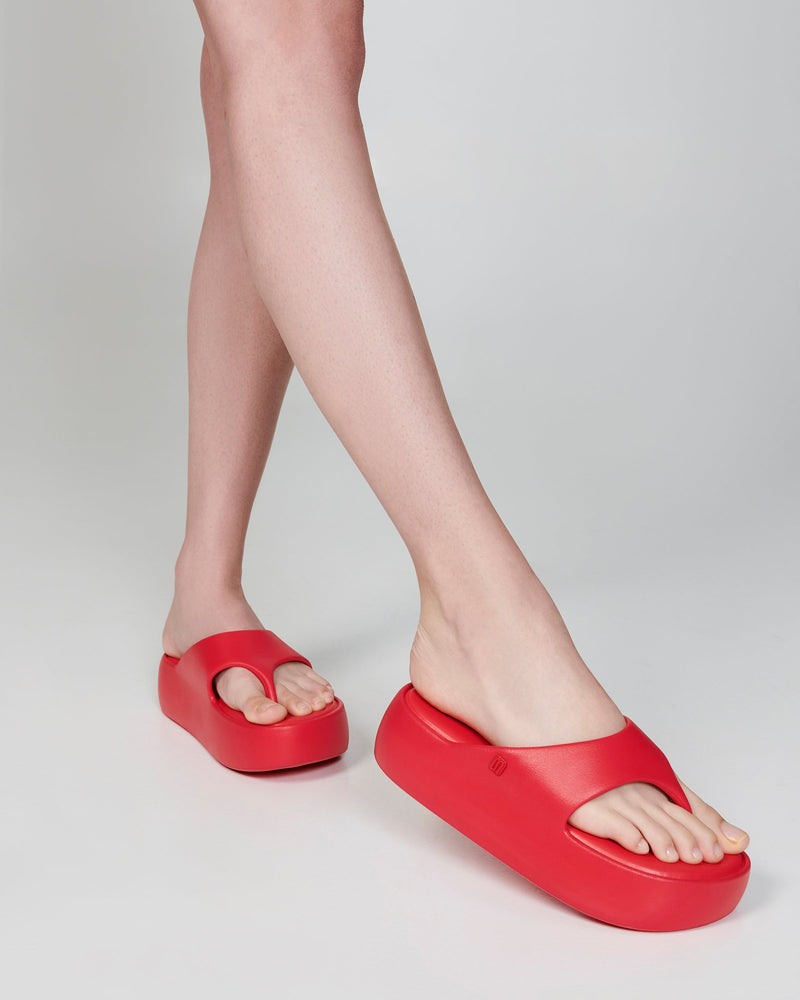 Model's legs wearing a pair of red Free Platform Thongs