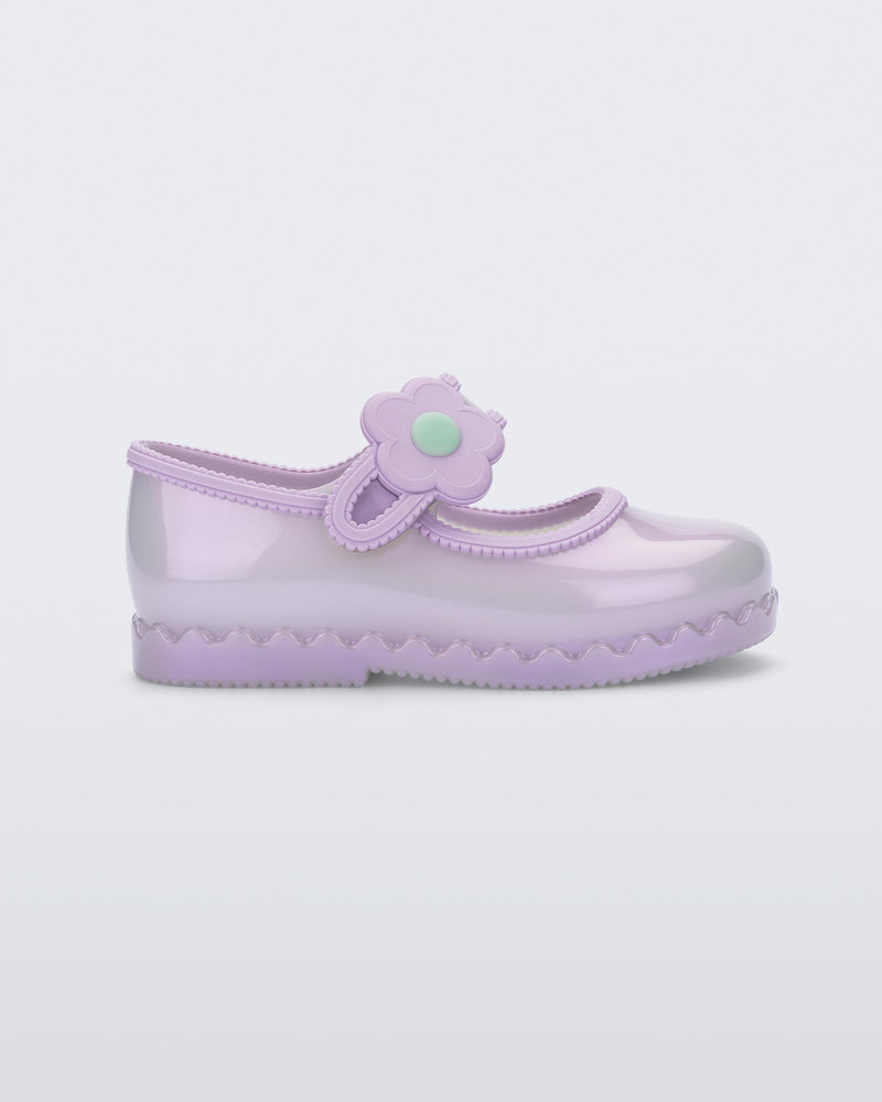 Side view of a pearly lilac Hip Ballerina baby flat with strap with flower