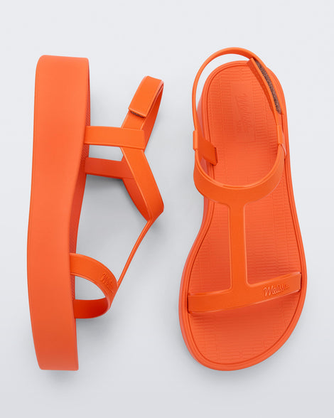 Top and side view of a pair of orange Sun Capri Platform sandals with ankle straps