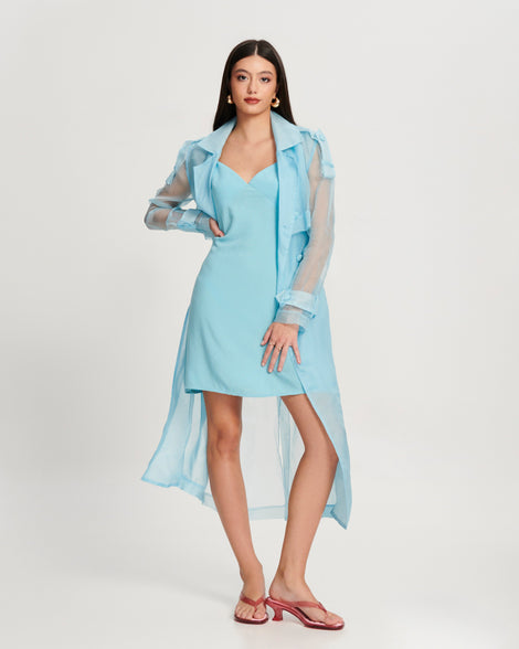 Model in a blue dress wearing a pair of pink Flip Flop Kitten Heels with clear pink straps
