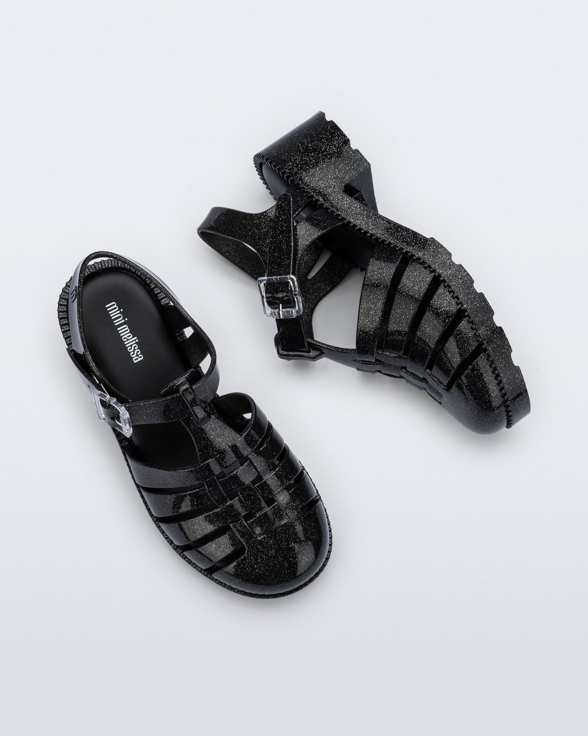 Side and top view of a pair of pearly black Possession Heel kids fisherman sandals