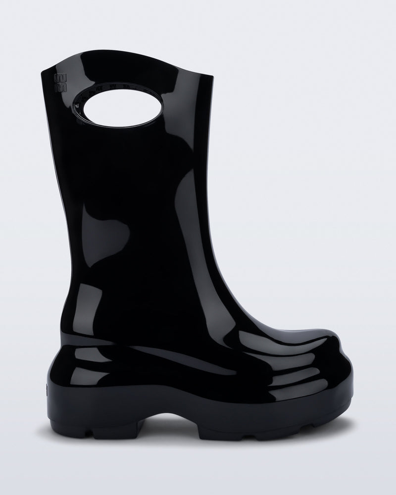 Side view of a black Ultra platform rain Boot with circle cutout on top