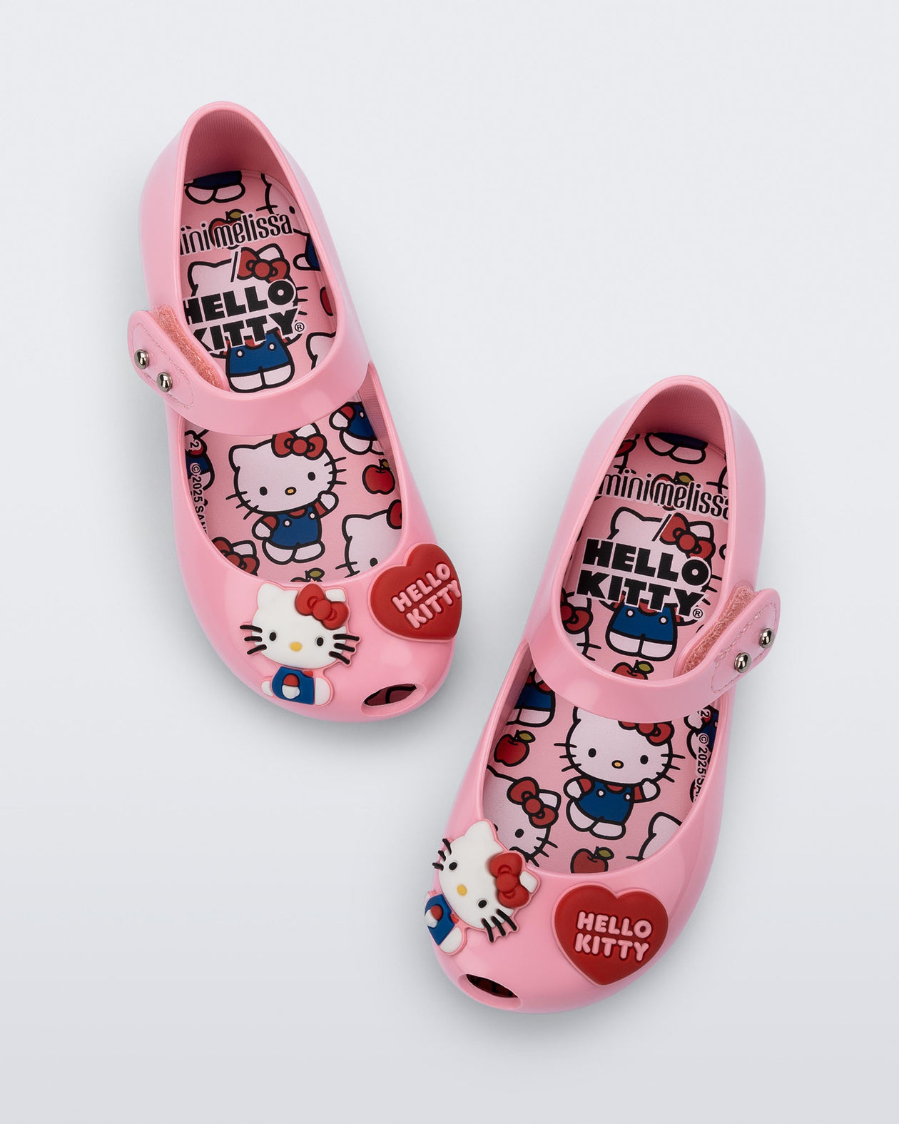 Top view of a pair of pink Ultragirl + Hello Kitty and Friends baby flats with Hello Kitty and a Heart on the upper