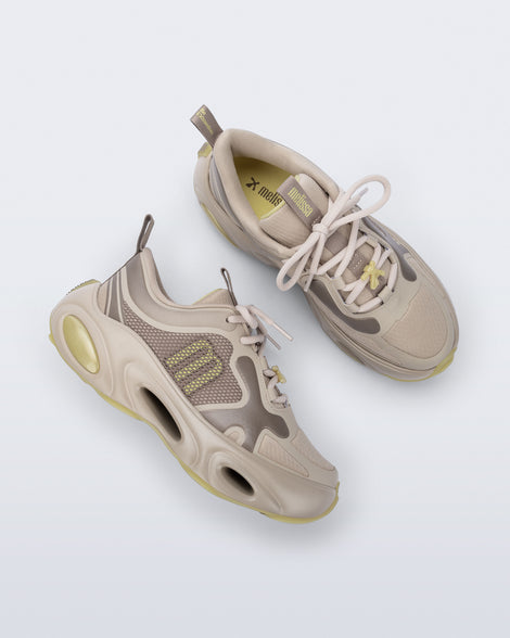 Top and side view of a pair of beige X Loop sneakers