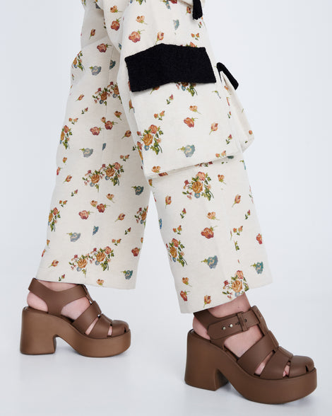 Model's legs in a pair of brown Lulu platform sandals