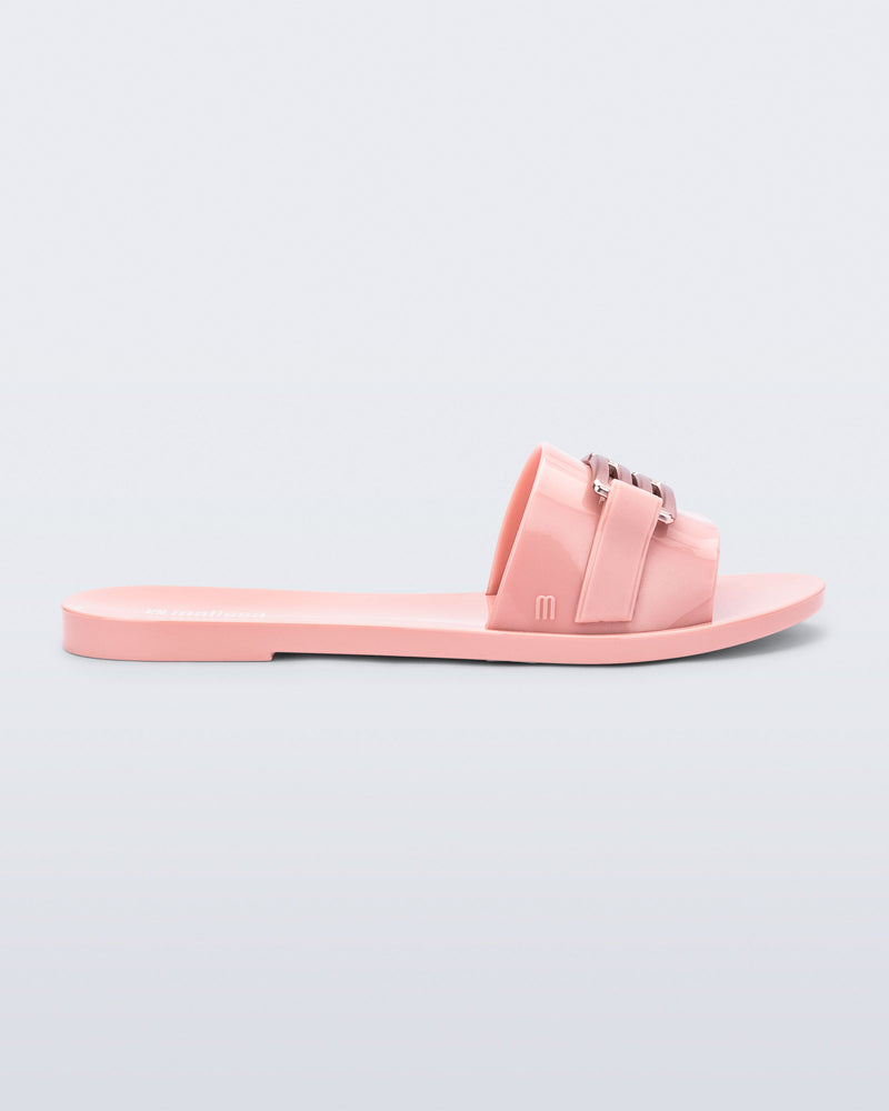 Side view of a pink Babe M Chic slide sandal.