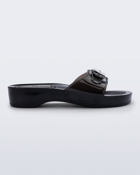 Side view of a black Pescura Heel + Scholl slide with top buckle