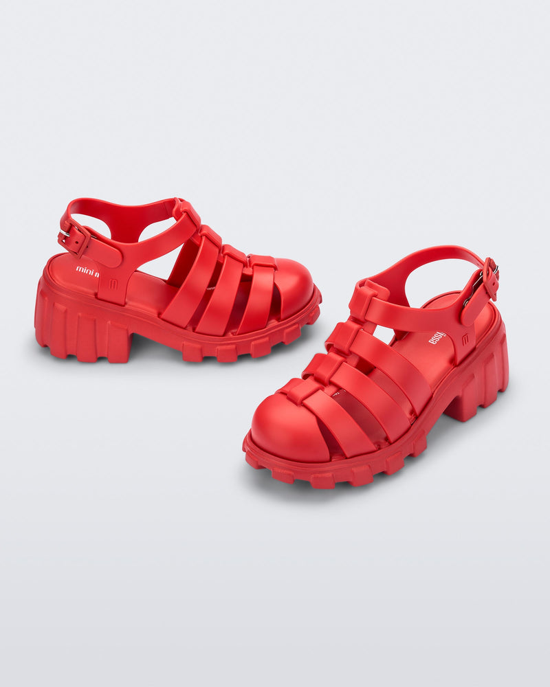 Side and angled view of a red kids Megan heeled sandal