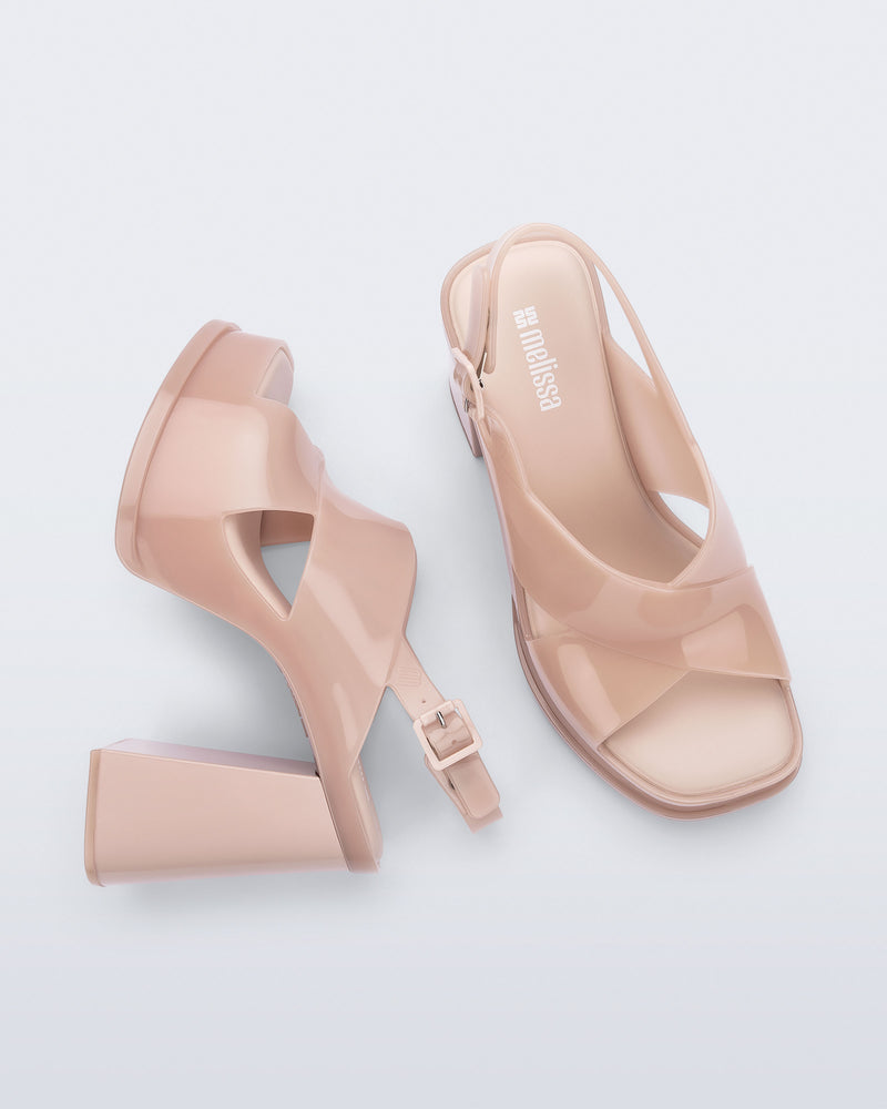 Top and side view of a pair of milky pink Dance Heel platforms with back adjustable strap