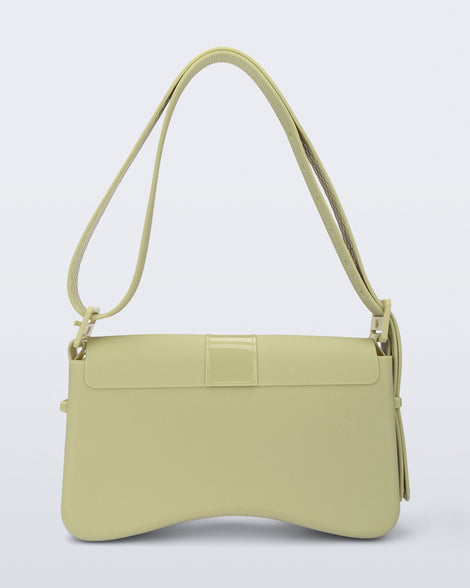 Back view of a pastel green Cargo bag with two small pockets on the front and an adjustable strap