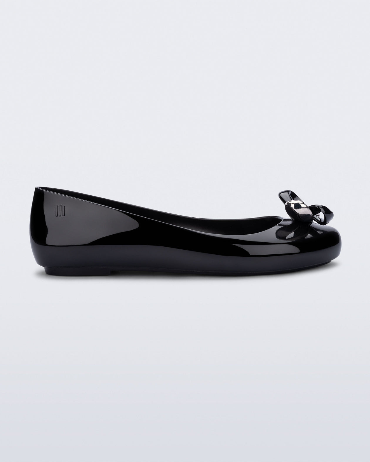 Side view of a black Sweet Love Glam ballerina flat with chrome bow
