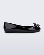 Side view of a black Sweet Love Glam ballerina flat with chrome bow