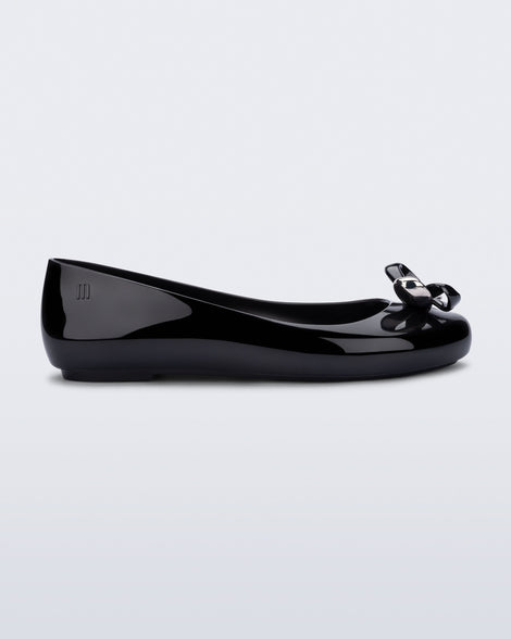 Side view of a black Sweet Love Glam ballerina flat with chrome bow