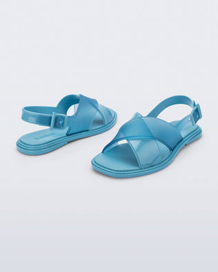 Back and angled view of a pair of blue Cleo sandals with back strap and crisscross top straps