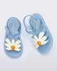 Top view of a pair of metallic blue Hip Bloomy baby sandals with beige daisy on top
