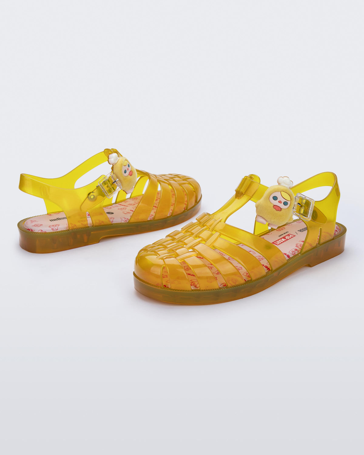 Back and angled view of a pair of transparent yellow Possession + Pop Mart Pucky fisherman sandals