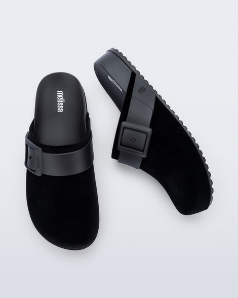Top and side view of a pair of black Cozy Clog Velvet slides