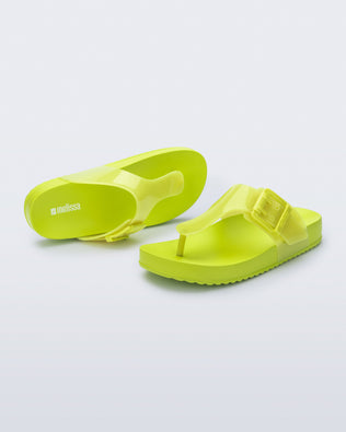 Top and angled view of a pair of green Cozy Flip flops