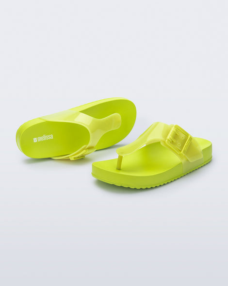 Top and angled view of a pair of green Cozy Flip flops