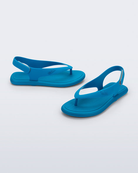 Side and angled view of a pair of blue Sun Samba thong sandals