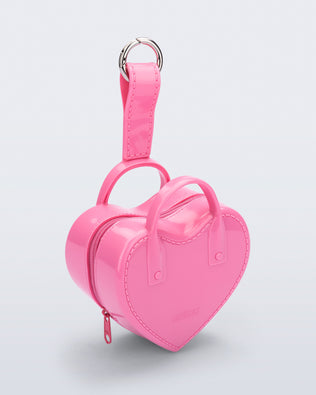 Angled view of a pink Heartbeat Pocket bag charm