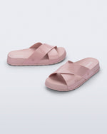 Side and angled view of a pair of pink Cozy Cross sandals with crisscross top straps