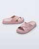 Side and angled view of a pair of pink Cozy Cross sandals with crisscross top straps