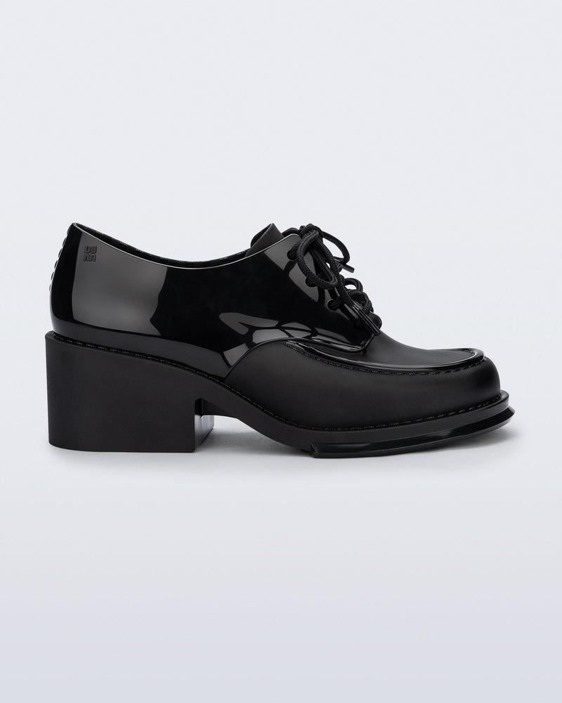 Side view of a black Tailor loafer with laces