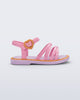 Side view of a pink Aurora baby sandal with purple sole and orange trim and buckle