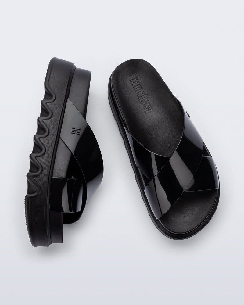 Top and side view of a pair of black Cozy Cross platform sandals with crisscross top straps