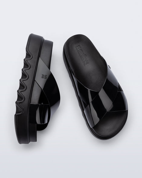Top and side view of a pair of black Cozy Cross platform sandals with crisscross top straps