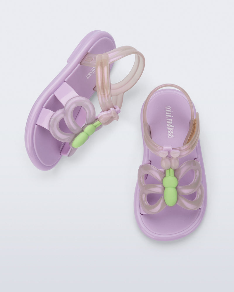 Side and angled view of a pair of lilac Hip Butterfly baby sandals