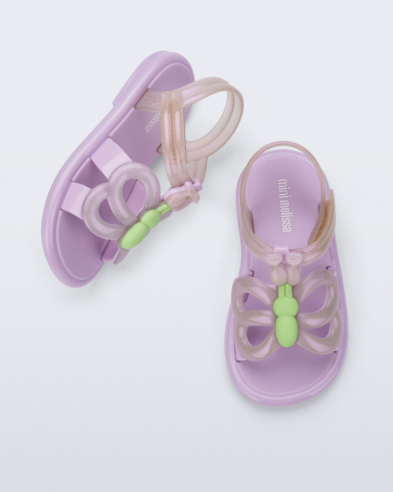 Side and angled view of a pair of lilac Hip Butterfly baby sandals
