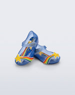 Angled view of a pair of glitter blue Ultragirl Colors baby flats with yellow star and rainbow on top