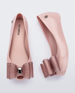 Side and top view of a pair of  light pink Ultragirl Classic Bow kids flats with glitter pink bow on top