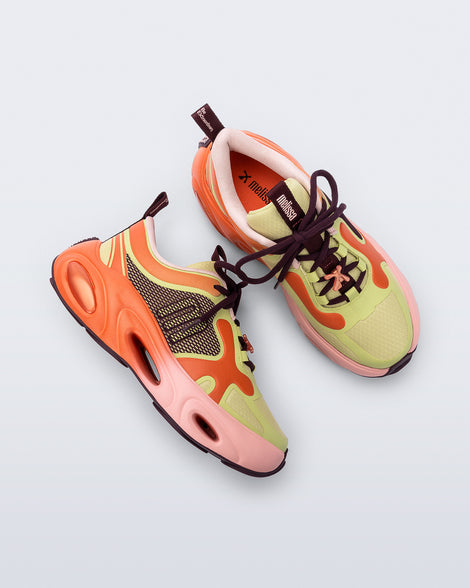 Top and side view of a pair of orange/green/pink X Loop sneakers