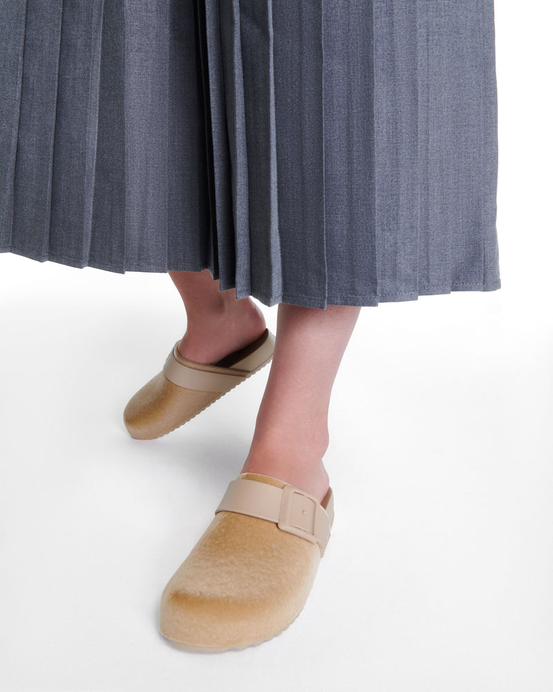 Model's legs wearing a pair of beige Cozy Clog Velvet slides