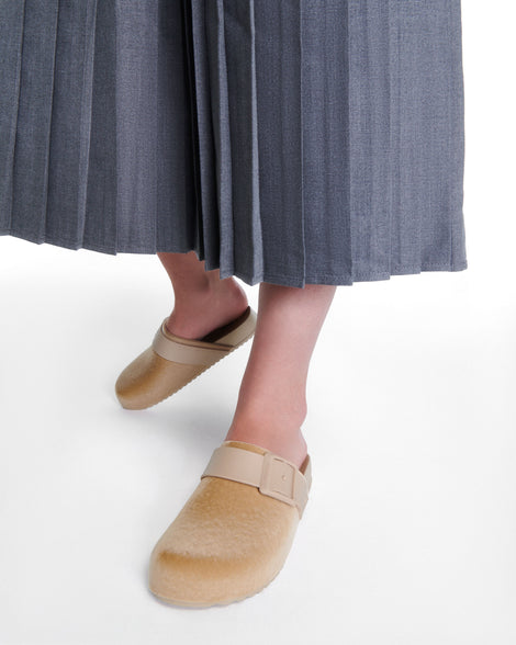 Model's legs wearing a pair of beige Cozy Clog Velvet slides