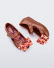 Top and side view of a pair of brown with orange star patterned bow Ultragirl Wonderland baby flats
