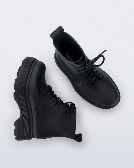 Top and side view of a pair of matte black Coturno Soft Platform boots