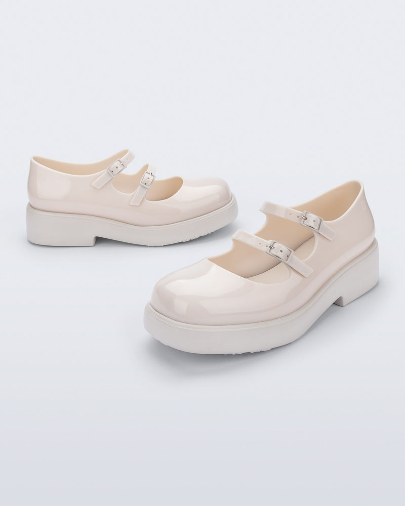Side and angled view of a pair of beige Farah Low Mary jane loafers