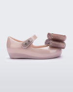 Side view of a light pink Ultragirl Classic bow baby flat glitter pink bow