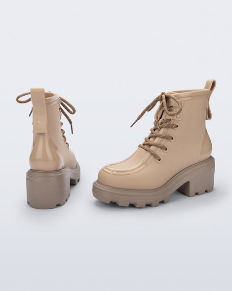 Back and angled view of a pair of beige Track Boot with small heel and beige laces