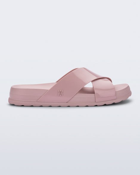 Side view of a pink Cozy Cross sandal with crisscross top straps