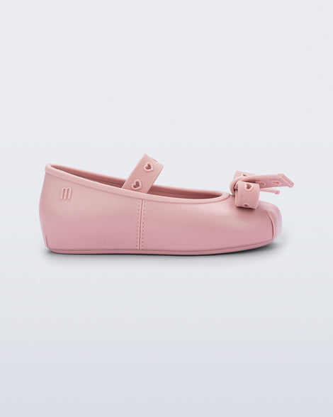 Side view of a pink Sophie Crush baby ballerina flat with bow