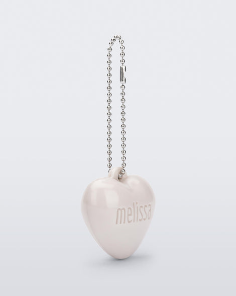 Angled view of a beige Heart Charm