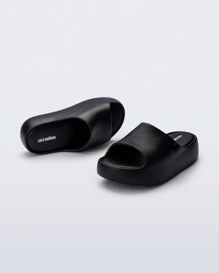 Angled top and front view of a pair of black Free Platform Slide kids sandals