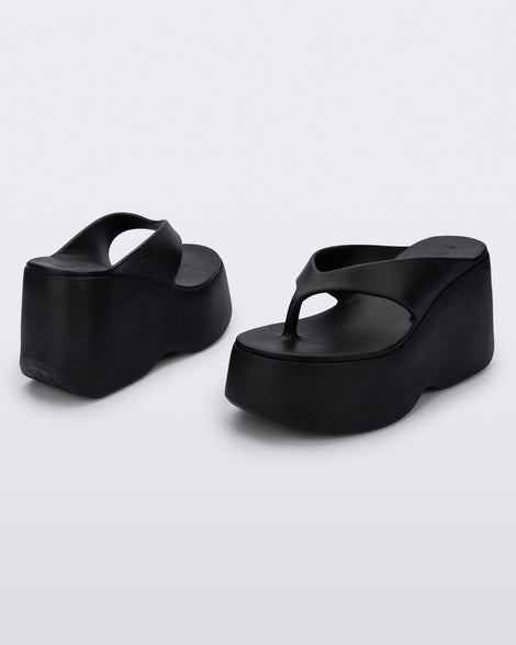 Back and angled view of a pair of black Free Thong  Wedge Platform heels