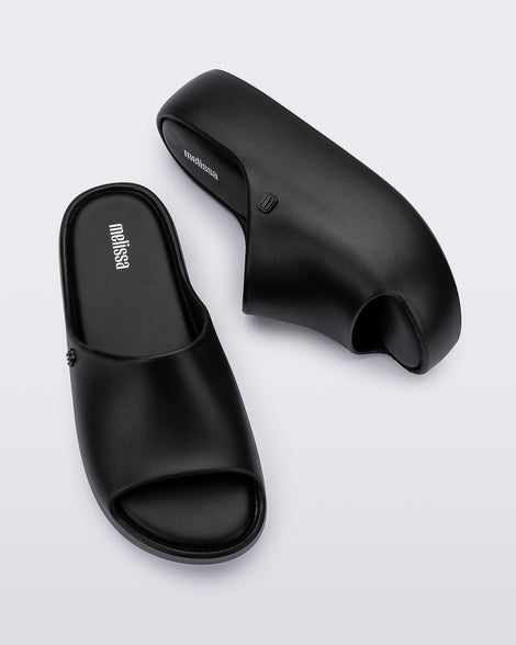 Top and side view of a pair of black Free Platform women's slides